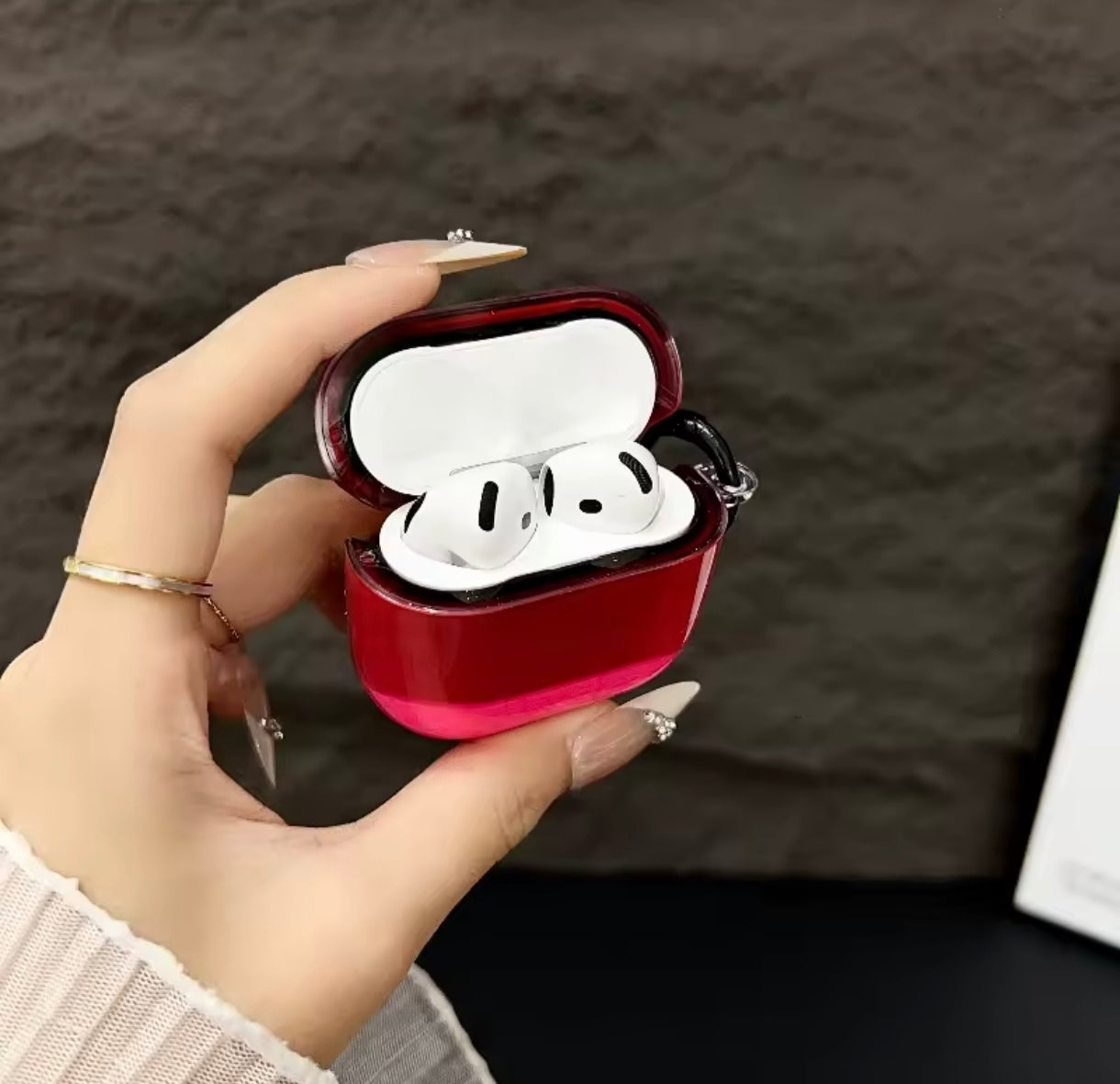 Headphone case in colors candies on a black background with floating light.